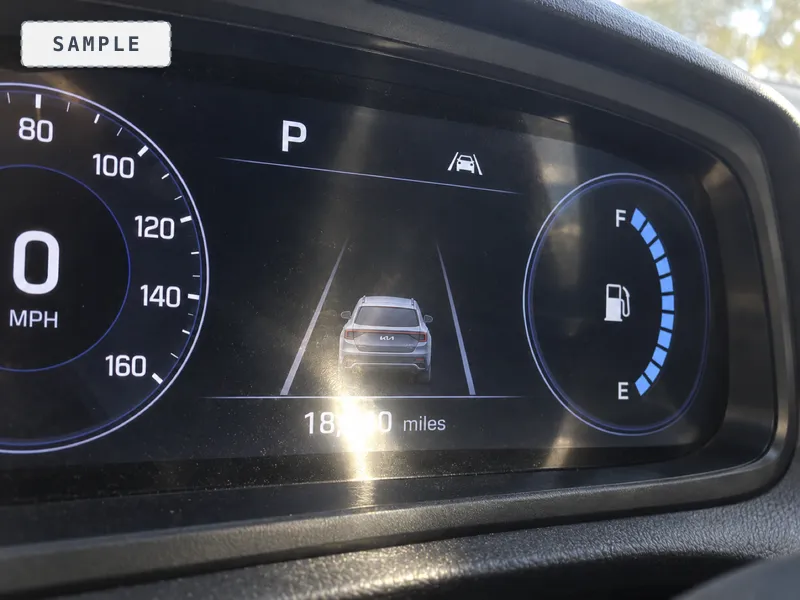 The mileage readout at an angle with glare across two digits