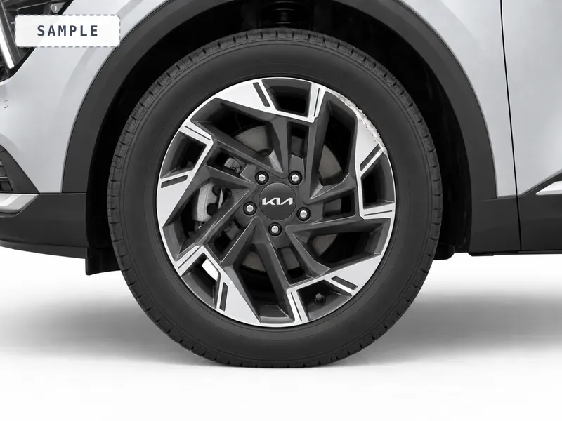 A two-tone alloy wheel with kerb rash on the rim