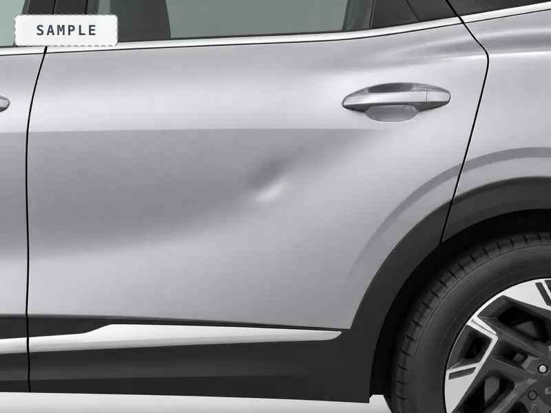 A shallow dent in a rear door, caught by side light
